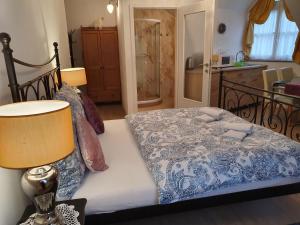 A bed or beds in a room at Karmelita Boutique Apartman