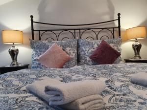A bed or beds in a room at Karmelita Boutique Apartman