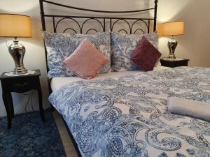 A bed or beds in a room at Karmelita Boutique Apartman