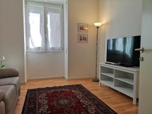 a living room with a television and a couch at Italianflat - Arena di Verona, Elegant 2 Bedrooms in Verona