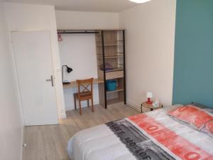 - une chambre avec un lit, un bureau et une chaise dans l'établissement Nouveau! Appartement 80m2 tout neuf avec 3 belles chambres, à Tours