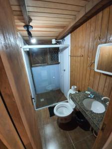 a small bathroom with a toilet and a sink at Residencial Rei Thomas in Capão da Canoa