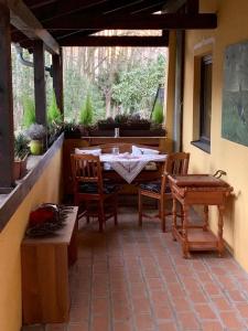 a porch with a table and chairs on a patio at Charming Apartment with Mountain View in Altmünster +8 photos