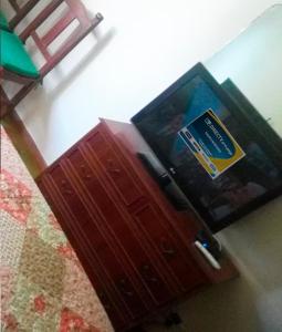 a wooden cabinet with a book on top of it at Nomeolvides in Tandil