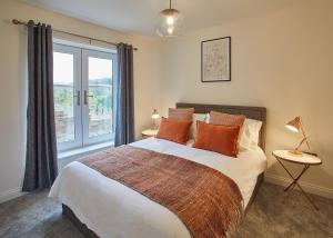a bedroom with a large bed and a window at Host & Stay - Hoggarths Retreat in Whitby