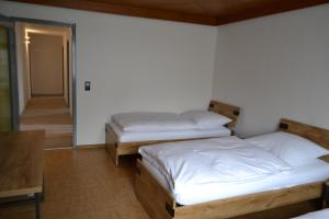 a bedroom with two beds and a hallway at Ferienwohnung Krone in Sankt Johann