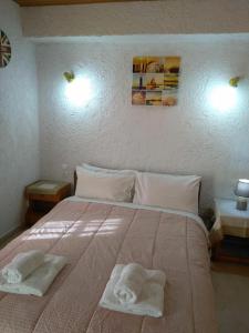 a bedroom with a large bed with towels on it at Villas Irene 5 Family Apartments in Kokkini Khanion