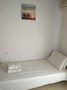 a white couch in a room with a picture on the wall at Villas Irene 5 Family Apartments in Kokkini Khanion