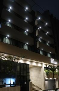 a building with a sign on it at night at Hotel El Salvador in Mexico City