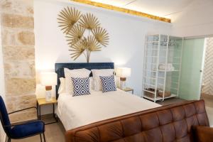 En eller flere senge i et værelse på VITORES BOUTIQUE APARTAMENTOS Rincón del Regidor