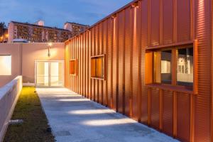 a wooden facade of a building with a walkway at Aparthotel ParKHo in Potenza