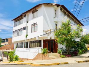 a white building on the corner of a street at Posada del Angel Hotel in Tarapoto