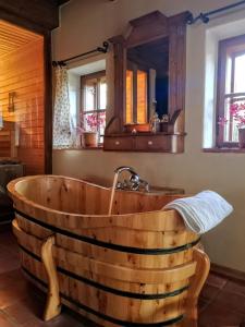 a wooden tub in a bathroom with a sink at Apartmány Červený Dvůr in Chvalšiny