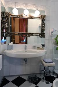 a bathroom with a white sink and a mirror at Hotel Farnese in Rome