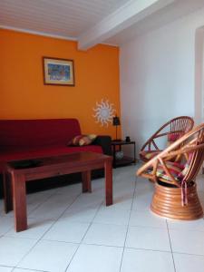 a living room with a couch and two chairs at La Villa Jasmin in Les Anses-dʼArlets