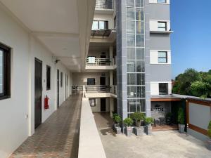 an empty hallway of an apartment building with potted plants at Rustic Crown Hotel in Alaminos