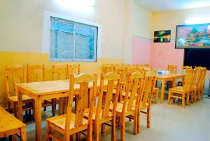 a dining room with wooden tables and chairs at Minh Anh Guesthouse in Sa Pa