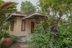 a small house surrounded by trees and plants at Bananas Resort & Restaurant in Tha Lane Bay +28 photos