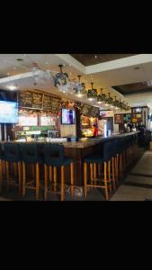 a bar with blue chairs in a restaurant at Makati CBD Resort 2 bedroom in Manila