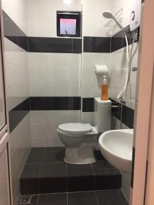 a bathroom with a toilet and a sink at COMFORTABLE STAY in Ayer Itam