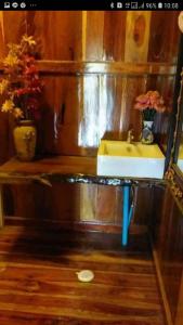 a bathroom with a yellow sink and a mirror at Pae Maldive Erawan in Chongsadao