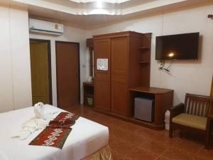 a hotel room with a bed and a television at Ocean View Resort in Ko Lanta