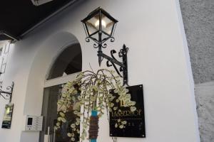 
a lamp post with a vase of flowers in front of it at Atel Hotel Lasserhof in Salzburg
