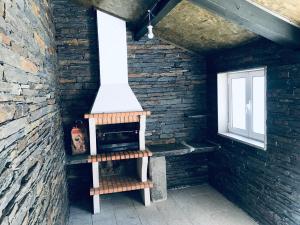 a stove in a room with a brick wall at duplex house un center village in Campeã
