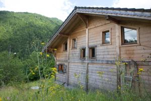 a wooden cabin in the middle of a field at Chalet La Pastorale in Morzine