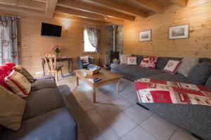 a living room with couches and a table at Chalet La Pastorale in Morzine