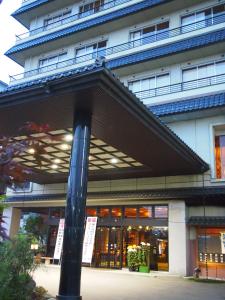 a building with a pole in front of it at Hotel Ohsho in Tendo