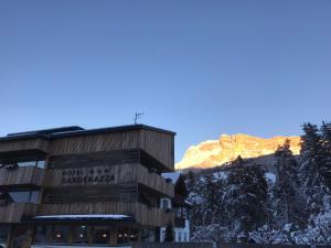 a building with a mountain in the background at Hotel Gardenazza in Badia