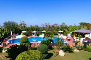 a resort with a swimming pool and some plants at Hotel Tirreno in Parghelia
