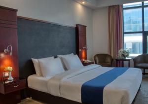 A bed or beds in a room at Torino Hotel Amman