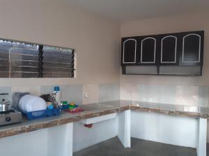 a kitchen with a counter top in a room at Veance Travellers Inn-Pabuas extension in Mambajao