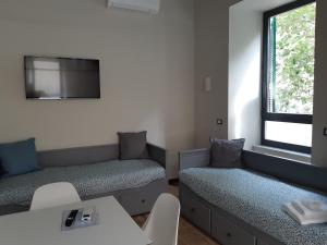 a room with two beds and a window at Il Giardino di Elettra - FreeParking in Genova