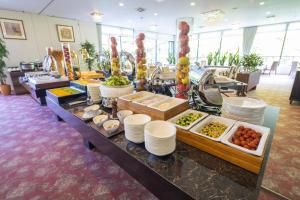 a buffet line with plates and food on a table at Hotel Marroad Karuizawa in Karuizawa