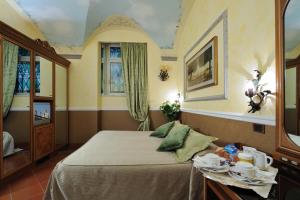 Postel nebo postele na pokoji v ubytování Hotel Farnese