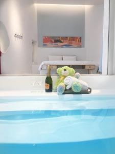a teddy bear sitting on a table with a bottle of wine at Sea Shore Hotel in Manzhou