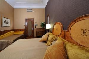 Postel nebo postele na pokoji v ubytování Hotel Farnese