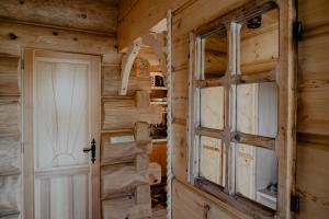 a door in a log cabin with a wall at Biolo i Corno Izba Mountain Chalets in Kościelisko +59 photos