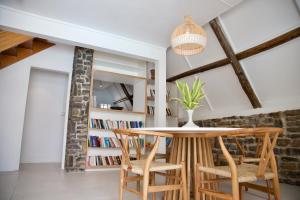 a dining room with a table and chairs and a book shelf at Blue Bird in Pereybere