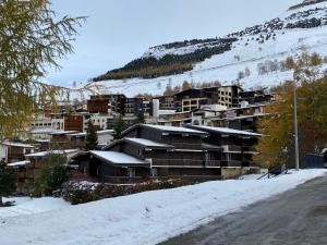 a group of buildings in the snow on a hill at The Ski Paradise 2 Alpes in Les Deux Alpes