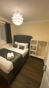 a bedroom with a large bed and a chandelier at Apartment 20 @ Excel London in London