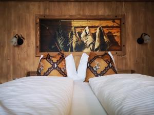 a bedroom with two beds and a painting on the wall at Stauders Zimmer und Ferienwohnungen in Innsbruck