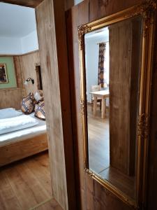 a mirror in a room with a bed and a bedroom at Stauders Zimmer und Ferienwohnungen in Innsbruck