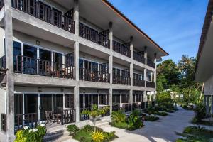 an exterior view of a building with balconies at Baan Suan Ta Hotel in Koh Tao