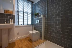 a bathroom with a toilet and a sink at Fairmead in Ambleside +25 photos