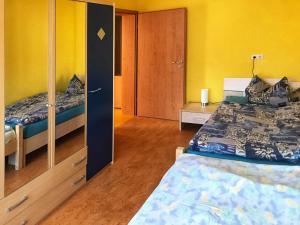 a bedroom with two beds and a cabinet and a bed sidx sidx sidx at Ferienwohnung Burgblick in Betzenstein