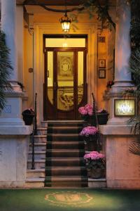 a front door of a building with stairs and flowers at Hotel Farnese in Rome